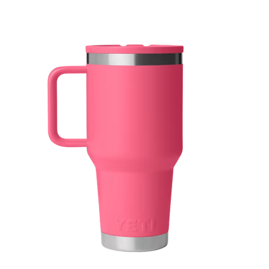 A bright pink YETI travel mug with a matching pink lid and handle, featuring stainless steel trim at the top and bottom, shown on a plain white background.