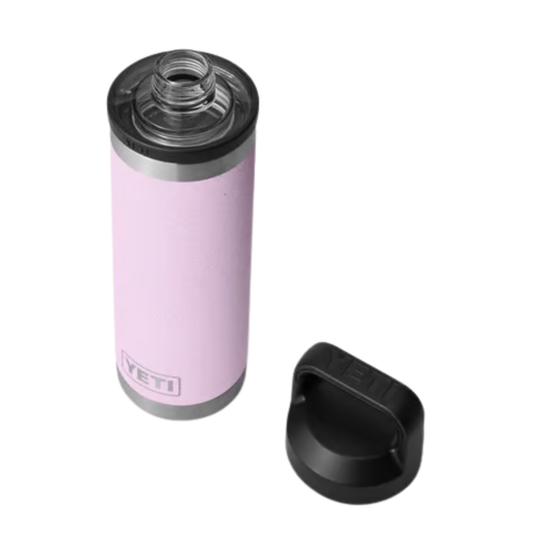 A light pink YETI insulated tumbler with a clear lid and a separate black lid placed beside it, shown on a plain white background.