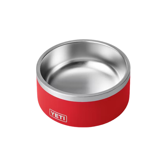 A red YETI pet bowl with a brushed stainless steel interior and rim, shown on a plain white background.