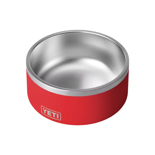 A red and stainless steel pet bowl with the YETI logo on the front, shown on a plain white background.