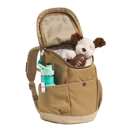 A tan canvas backpack shown open on a white background, with a stuffed dog toy, a brown football, and a mint green water bottle stored inside or in the side pocket.
