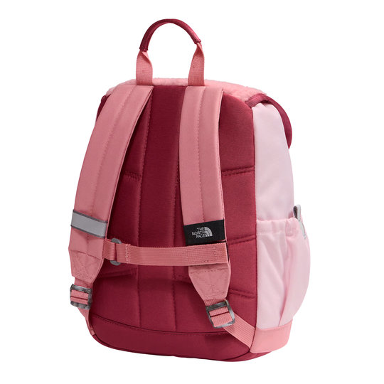 The front view of a pink and burgundy backpack from The North Face, featuring padded shoulder straps, a top carry handle, a side pocket, and a reflective strap on a white background.