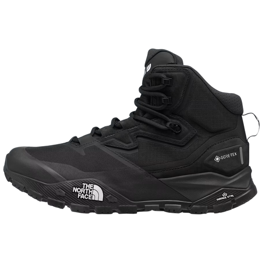 A black mid-top hiking boot by The North Face, featuring a lace-up design, high collar, and rugged sole, shown against a plain white background.