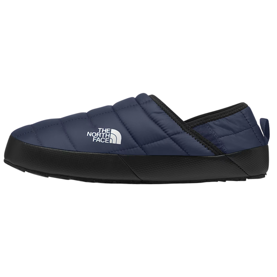 A single navy blue quilted slip-on shoe by The North Face, featuring a white logo on the side, a black sole, and a black elasticized opening, shown against a plain white background.