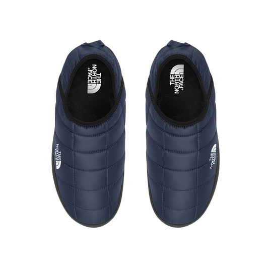 A pair of navy blue quilted slip-on shoes by The North Face, shown from a top-down view on a white background.
