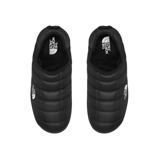 A pair of black quilted slip-on shoes by The North Face, shown from a top-down view on a solid white background.