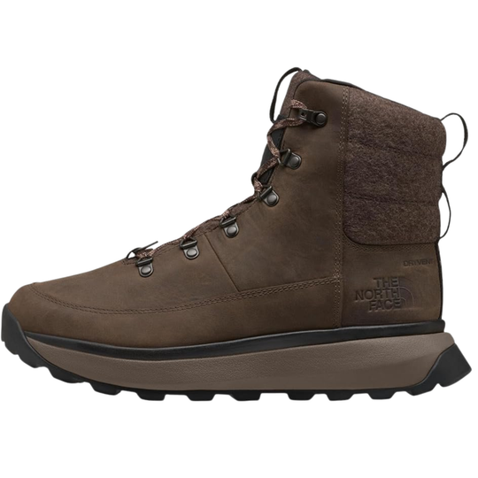A brown mid-cut hiking boot from The North Face, featuring a textured suede upper, lace-up closure, and a thick brown and black sole, shown against a plain white background.