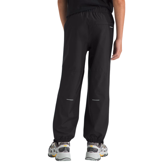 Black pants worn by a person on a white background