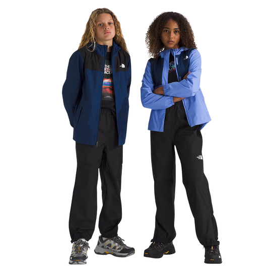 Two models wearing The North Face outdoor apparel, including jackets and pants, standing against a plain white background.