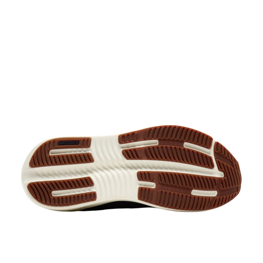 The outsole of a sneaker, showing a brown treaded bottom with a white midsole and a small black 'SABRE' logo on the heel.