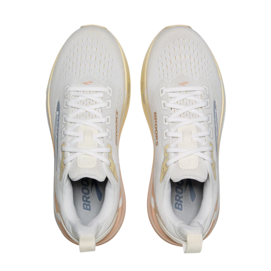 A pair of Brooks running shoes in white with light beige and gold accents, shown from a top-down view on a white background.