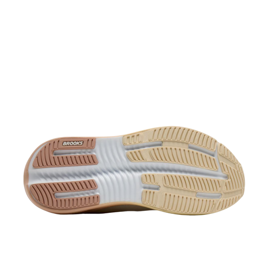 The outsole of a Brooks sneaker, showing a white ribbed center with tan and light brown textured rubber sections on the heel and toe, on a plain white background.