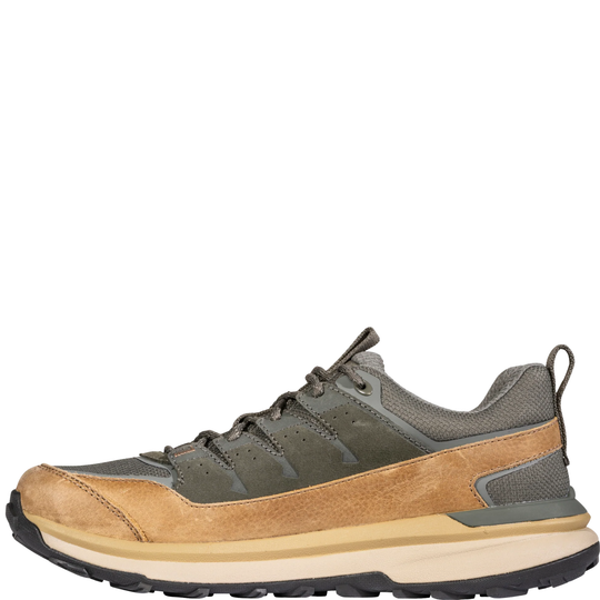 A low-top hiking shoe shown in a side profile view against a plain white background. The shoe features a tan suede upper, dark olive green mesh panels, a beige midsole, and a black outsole.