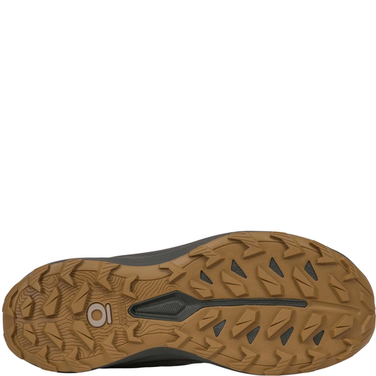 A close-up top-down view of a shoe's brown rubber outsole, showing deep tread patterns and a small circular logo on a white background.