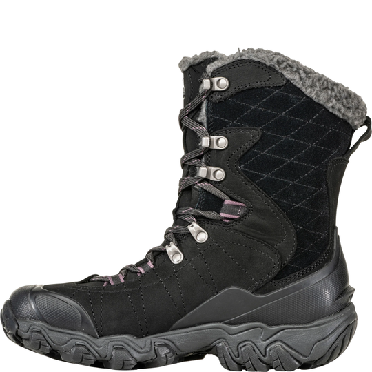 Black winter boot with quilted design and fur lining on a white background