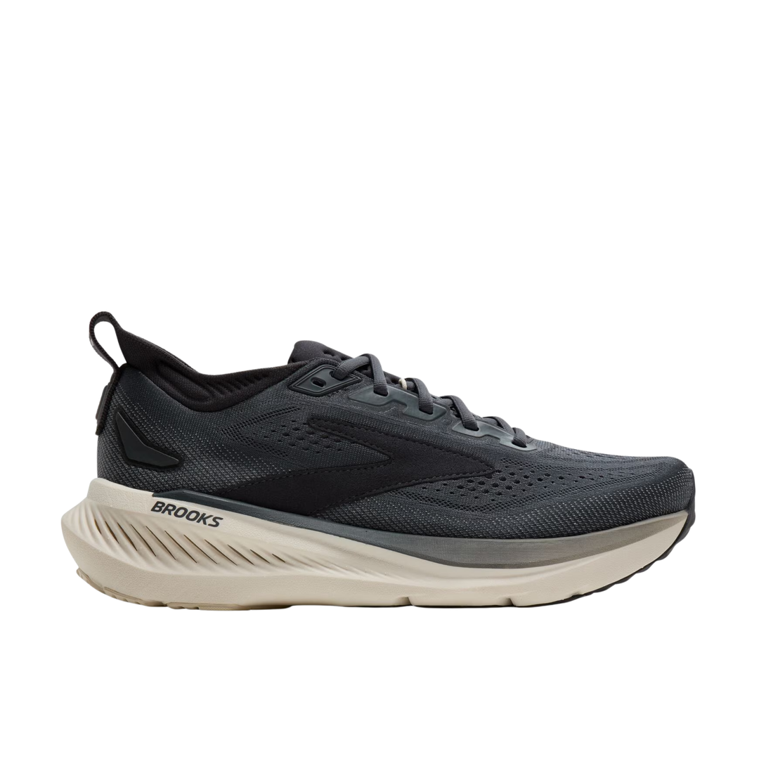 Brooks running shoe in dark gray and black with a thick beige midsole, shown from the side on a white background.