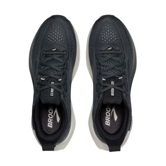 Black running shoes with visible 'Brooks' logo on a white background
