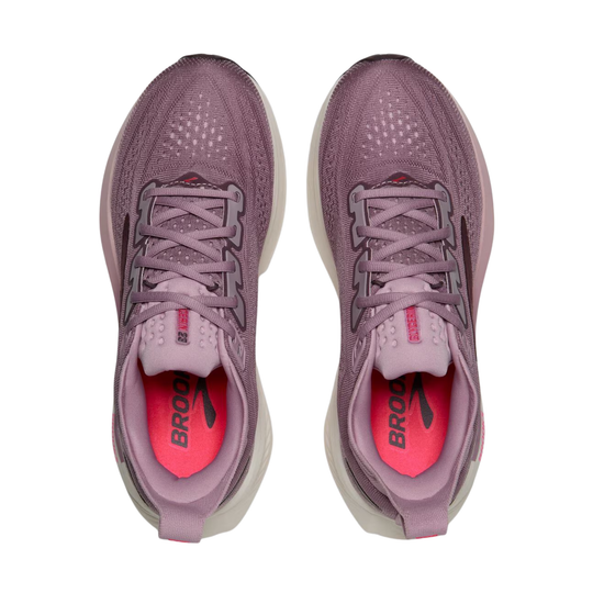 A pair of Brooks running shoes in a dusty mauve-purple colorway, shown from a top-down view against a solid white background. The shoes feature a textured knit upper, matching purple laces, and a bright pink interior lining with the black Brooks logo.
