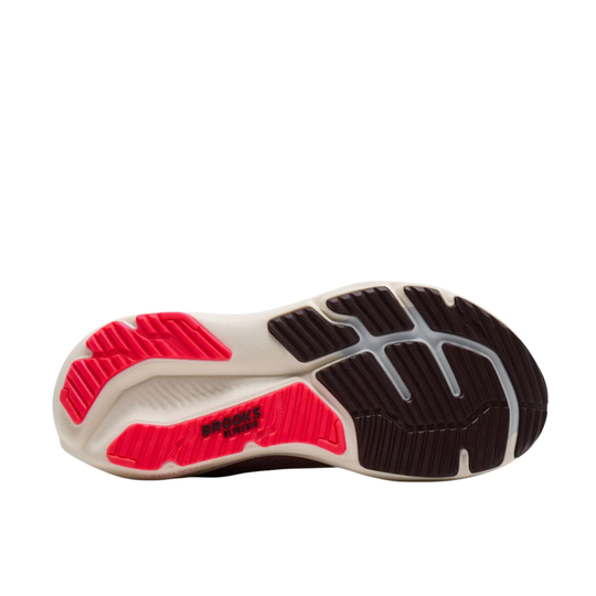 The outsole of a running shoe shown from a top-down view, featuring a white midsole with bright pink and black textured grip patterns.
