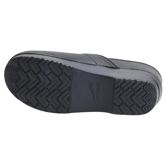 A black slip-on shoe shown from the sole side, featuring a textured chevron tread pattern and a molded logo on the heel, set against a plain white background.