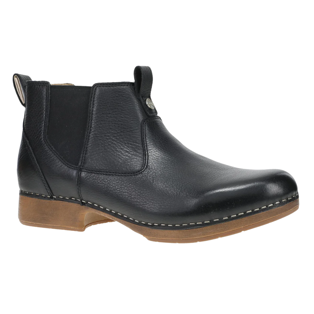 A black leather Chelsea ankle boot with a brown stacked sole, shown from a side profile on a white background.