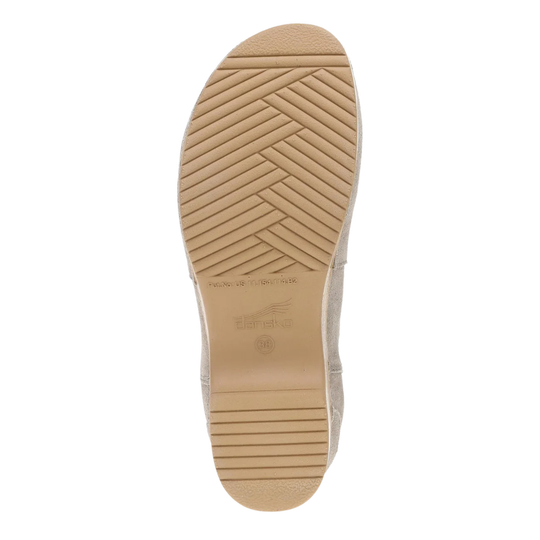 The tan rubber outsole of a shoe, showing a herringbone tread pattern and the embossed brand name 'Dansko' on a white background.