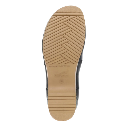 The outsole of a black shoe, showing a tan rubber tread with a herringbone pattern and embossed branding, photographed on a solid white background.