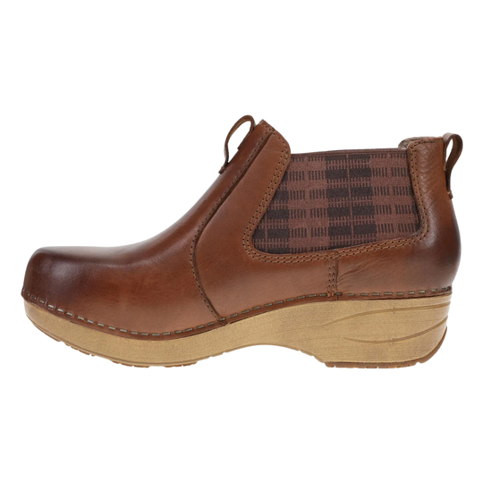 A brown leather ankle boot with a brown and black plaid elastic side panel and a light tan wedge sole, shown in profile against a white background.