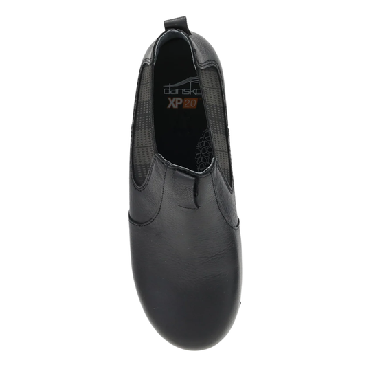 Black slip-on shoe with 'Dansko' branding on a white background