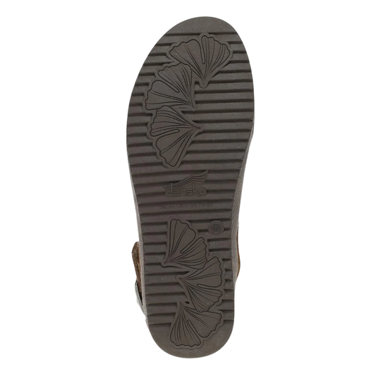 The outsole of a brown sandal, featuring a dark gray tread pattern with embossed ginkgo leaf designs and the brand name 'JAPAN' visible in the center.