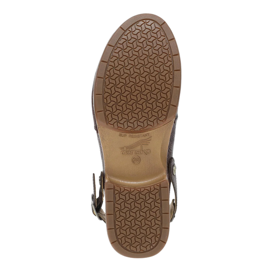 The outsole of a brown leather sandal, showing a textured geometric tread pattern and the embossed brand name 'Dansko' on a white background.