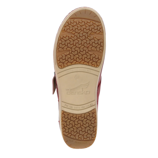 Tan sole of a sandal with a visible brand logo on a white background