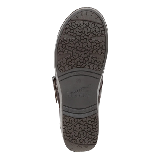 The outsole of a dark brown leather shoe, showing a textured tread pattern and the embossed brand name 'Dansko' in the center, isolated on a white background.