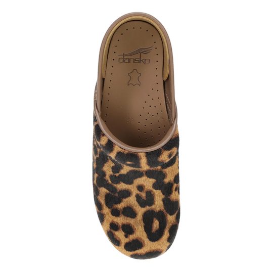 A single mule slipper with a brown and black leopard print upper, shown from a top-down view on a white background. The insole features the 'dansko' brand logo.