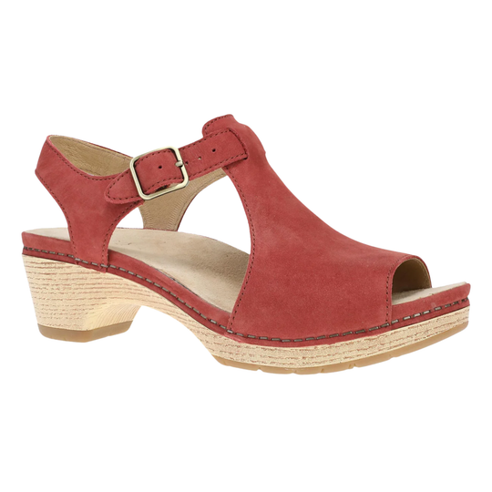 A red suede T-strap sandal with an open toe, adjustable ankle strap with a silver buckle, and a natural cork-wrapped wedge heel, shown from a side profile on a white background.