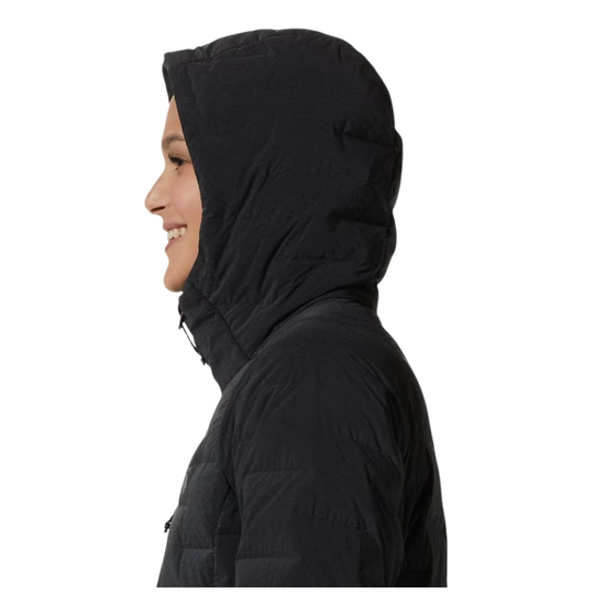 A side profile of a person wearing a black hooded puffer jacket against a plain white background.