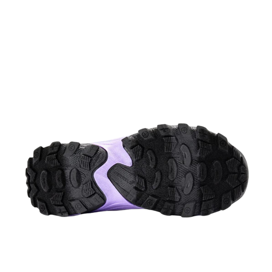 A close-up bottom view of a black athletic shoe showing its rugged treaded outsole with a light purple accent in the center, set against a plain white background.