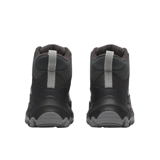 A pair of dark gray and black mid-height athletic sneakers shown from the back, featuring gray heel pull tabs and textured soles, set against a plain white background.