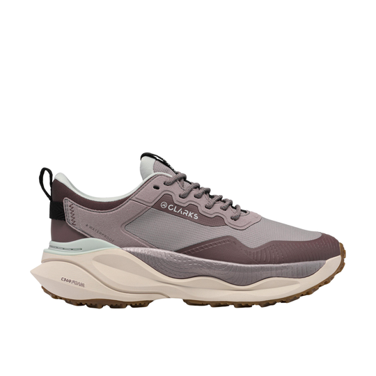A Clarks outdoor sneaker in a muted taupe and gray colorway, featuring a chunky cream midsole and a black heel pull tab, shown from a side profile on a white background.