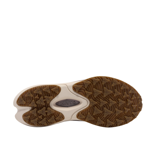 The outsole of a shoe shown from a top-down view, featuring a textured brown tread pattern with a central white section and a small gray brand plate.