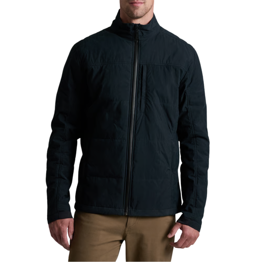 A man wearing a black quilted zip-up jacket and tan pants, shown from the chin down against a plain white background.