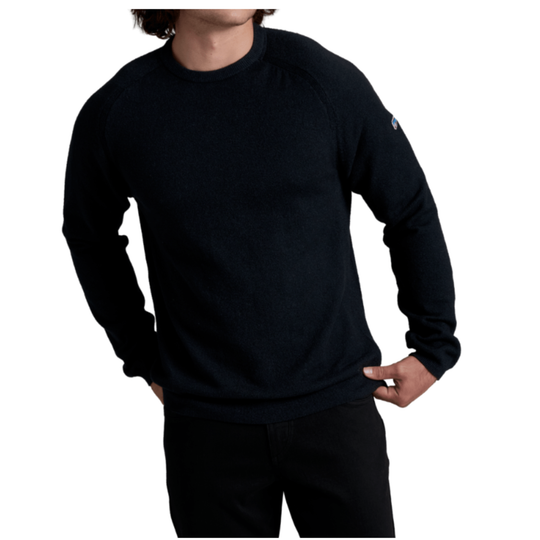 A man wearing a dark navy blue long-sleeve crewneck sweater, shown from the chin down against a plain white background.