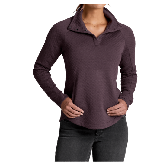 A woman wearing a dark plum long-sleeve quarter-zip pullover with a textured diamond-quilted pattern, paired with dark gray jeans, shown against a plain white background.