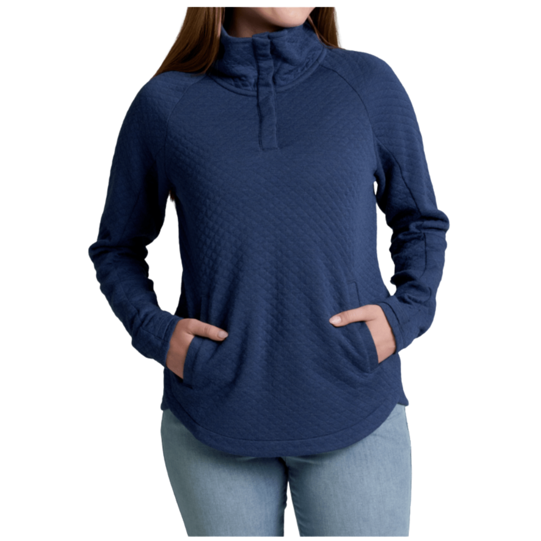 A woman wearing a navy blue long-sleeve quarter-zip pullover with a quilted texture and side pockets, paired with light blue jeans, shown against a plain white background.