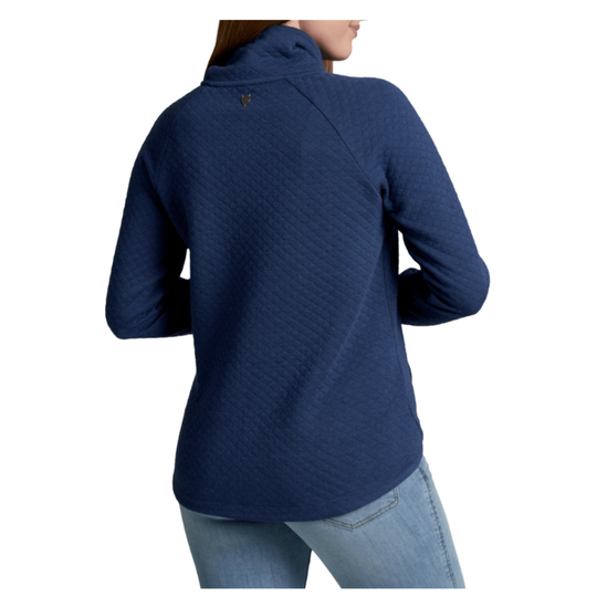 A woman shown from the back wearing a navy blue quilted long-sleeve top with a mock neck, paired with light blue jeans, against a plain white background.