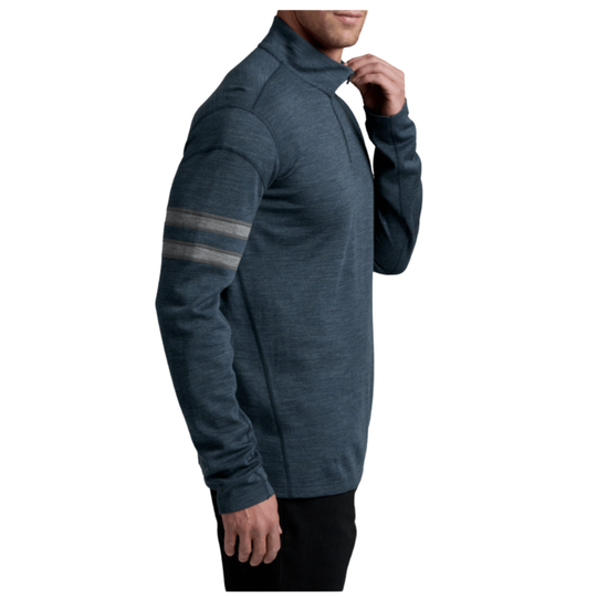 A man wearing a dark slate blue heathered quarter-zip pullover with two horizontal gray stripes on the right sleeve, shown in profile against a white background.