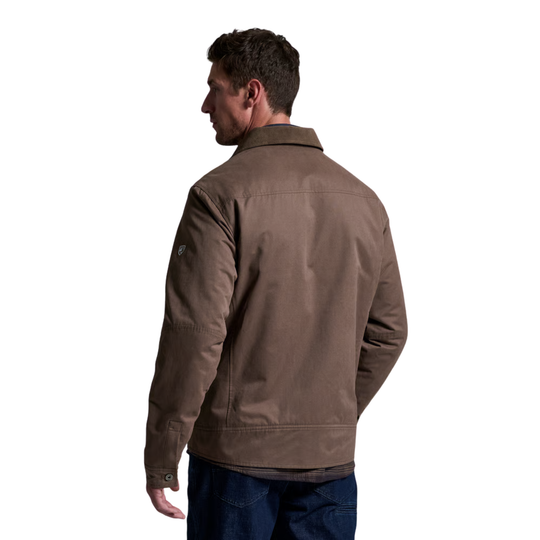 A man shown from the back wearing a brown utility jacket and dark blue jeans, photographed against a solid white background.