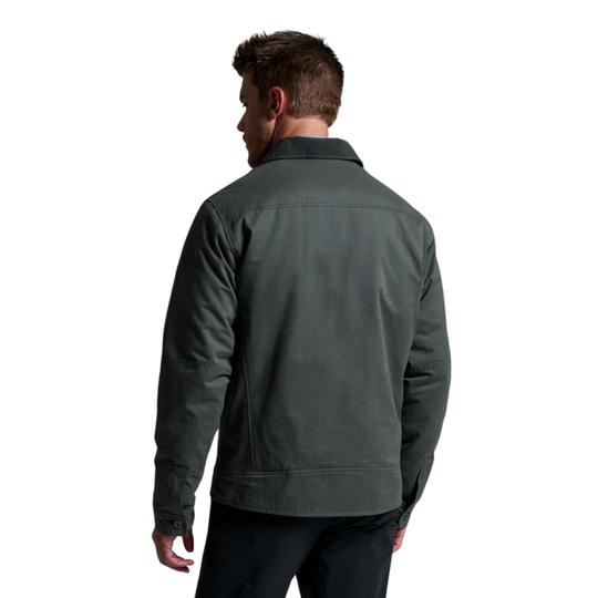 A man viewed from the back wearing a dark gray utility jacket and dark pants, set against a plain white background.