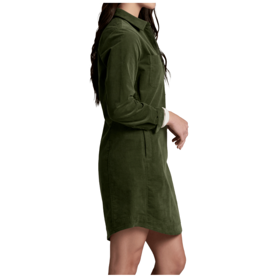 A woman wearing an olive green corduroy shirt dress, shown from a side profile view against a plain white background.