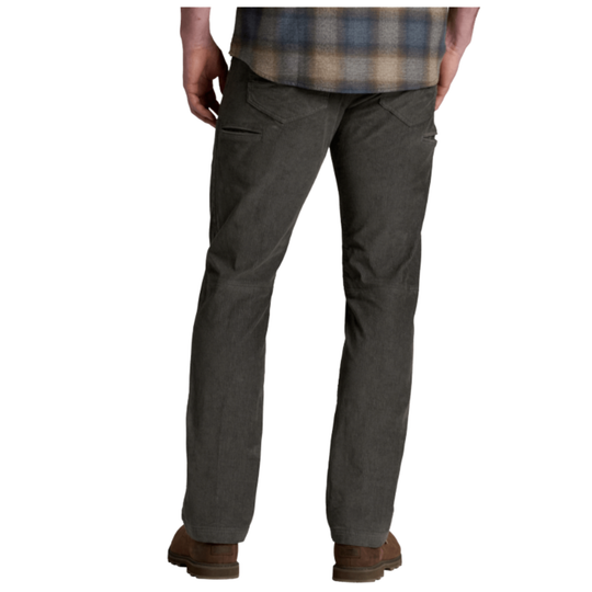 A person shown from the waist down wearing dark charcoal gray work pants, a blue and tan plaid shirt, and brown boots against a plain white background.